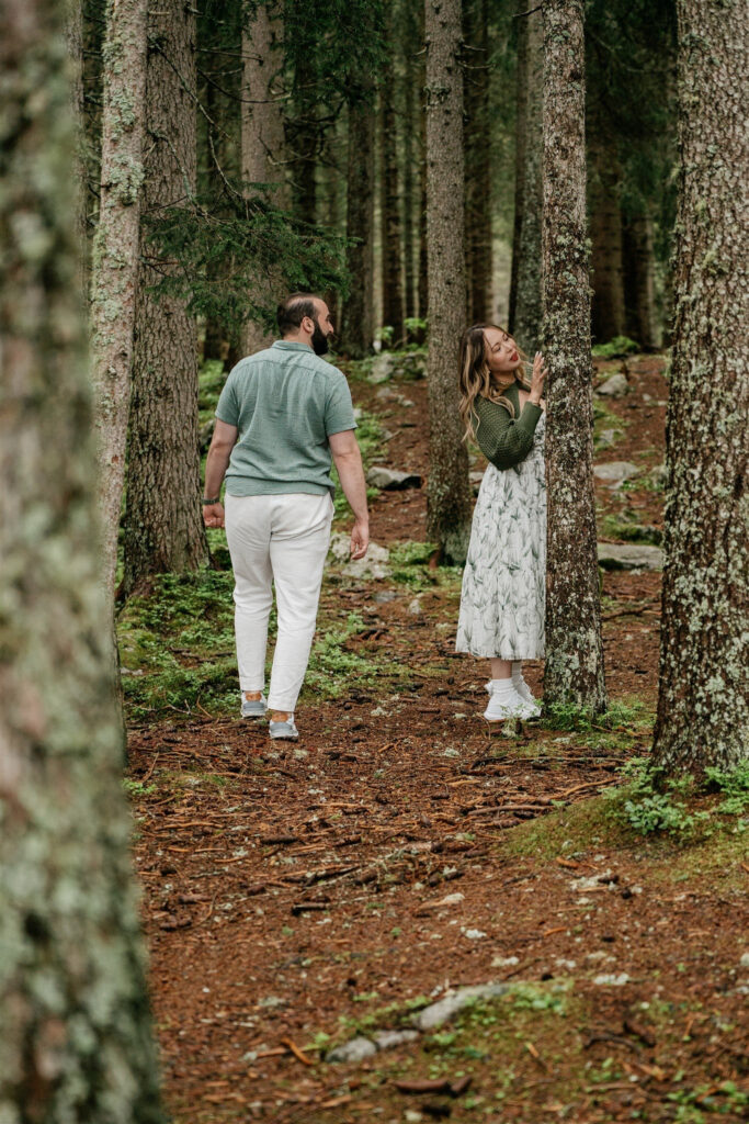 Couple exploring lush green forest trail