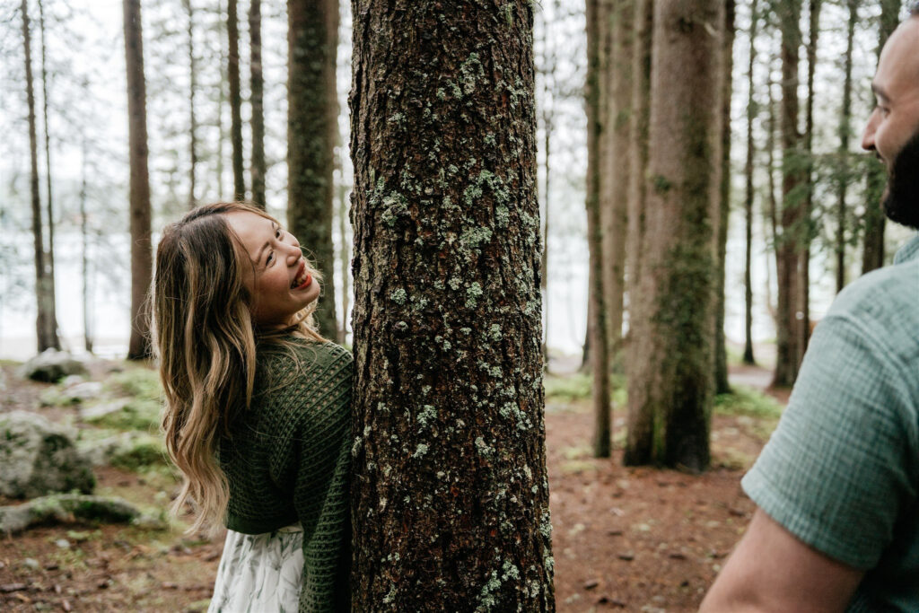 People enjoying playful moment in forest.