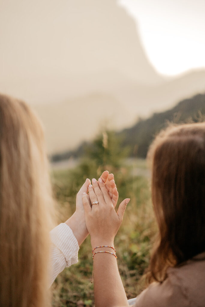 Couple holding hands in scenic nature view.