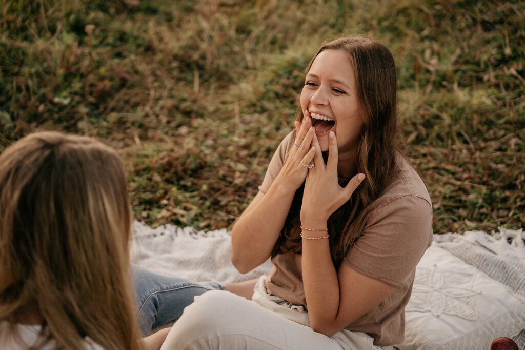 Woman joyfully surprised during outdoor picnic