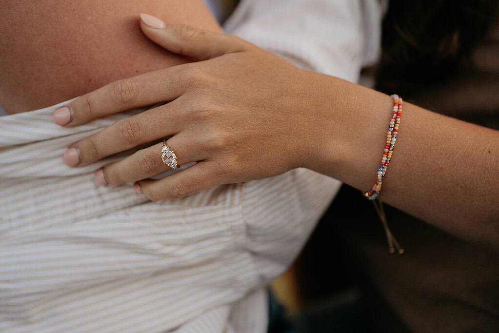 Hand with diamond ring and beaded bracelet