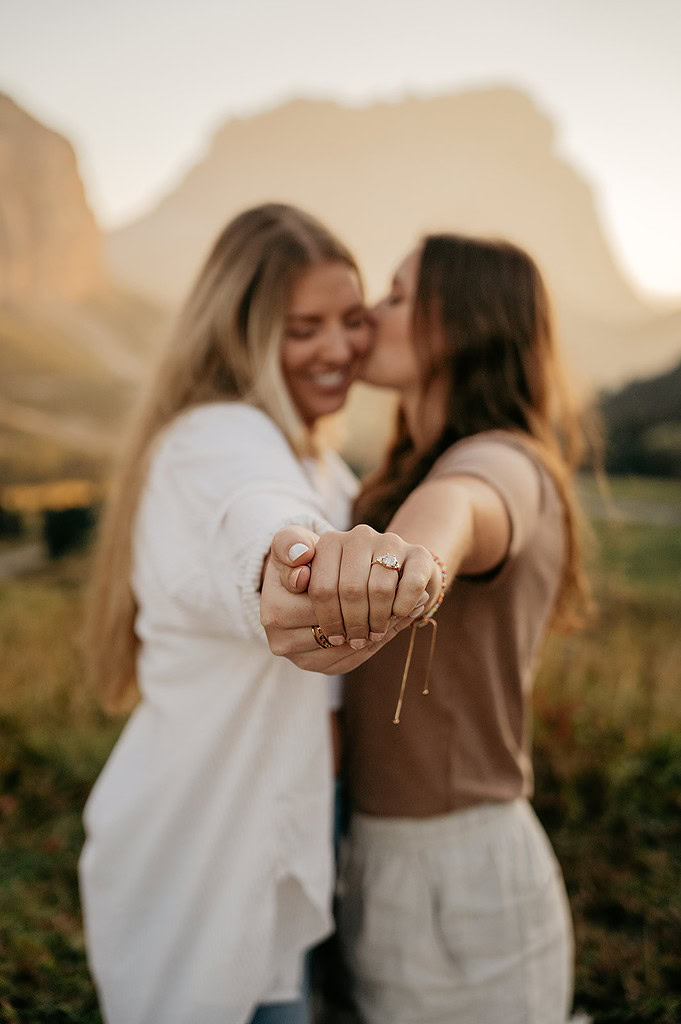 Two women holding hands in nature