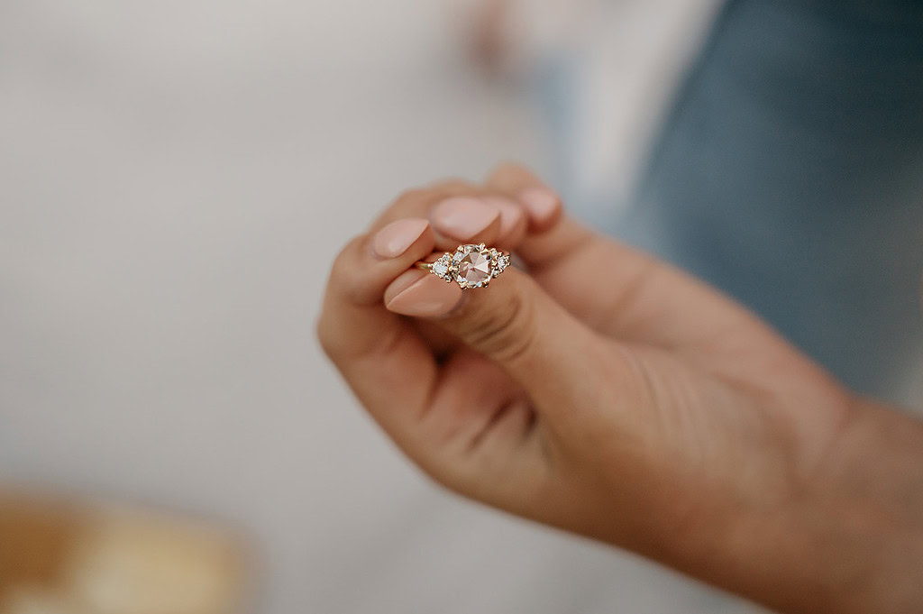 Hand holding elegant diamond engagement ring