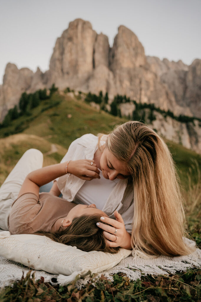 Couple relaxing outdoors with mountain view.