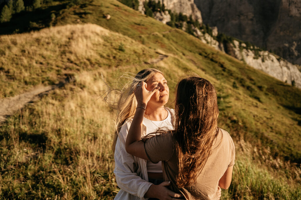 Couple embracing in picturesque mountain landscape scene.