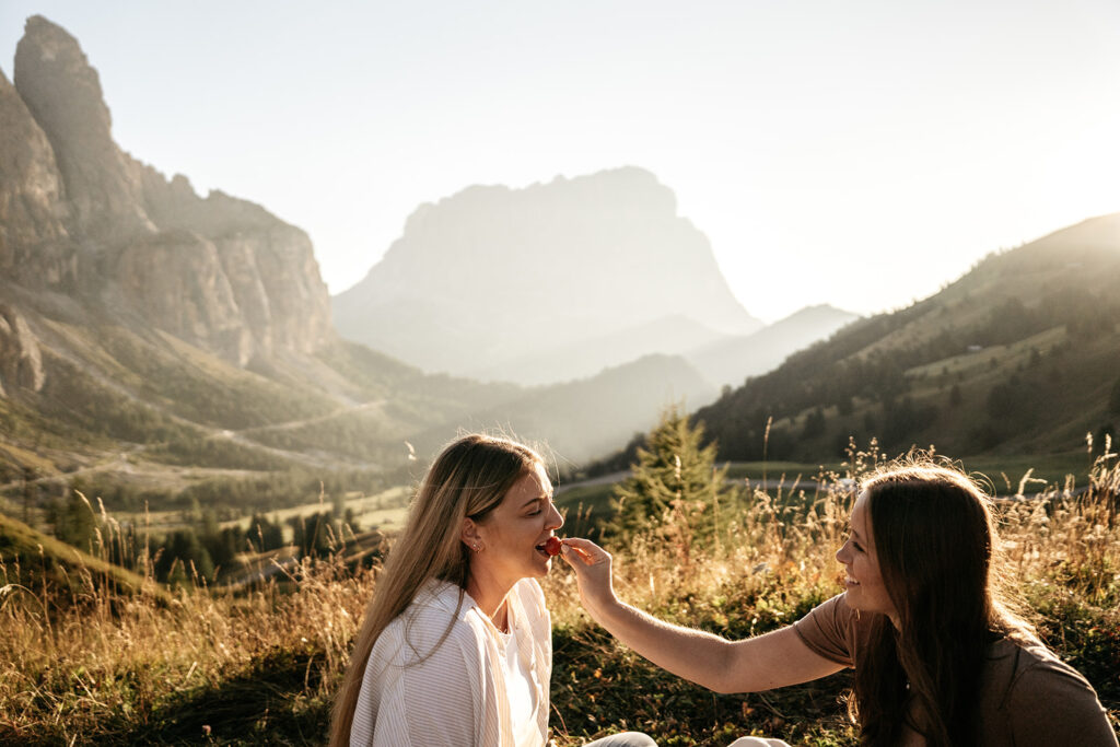 Women enjoying picnic in scenic mountain landscape.