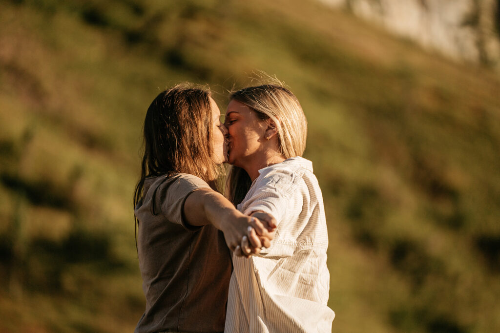 Couple kissing in sunny outdoor setting