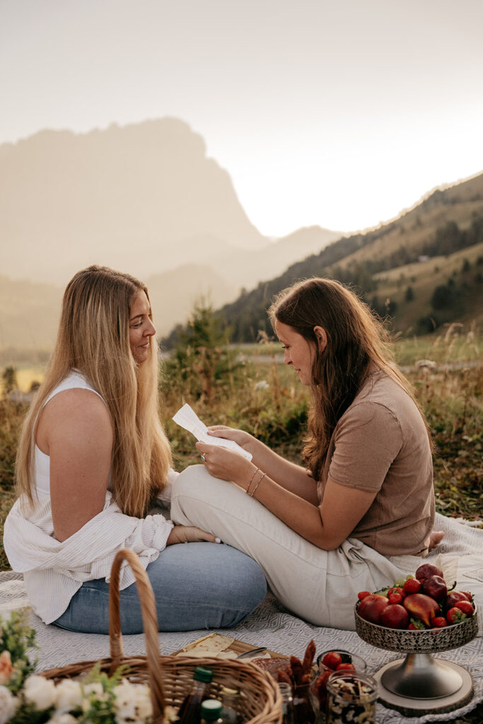 Two women enjoying a picnic in the mountains.