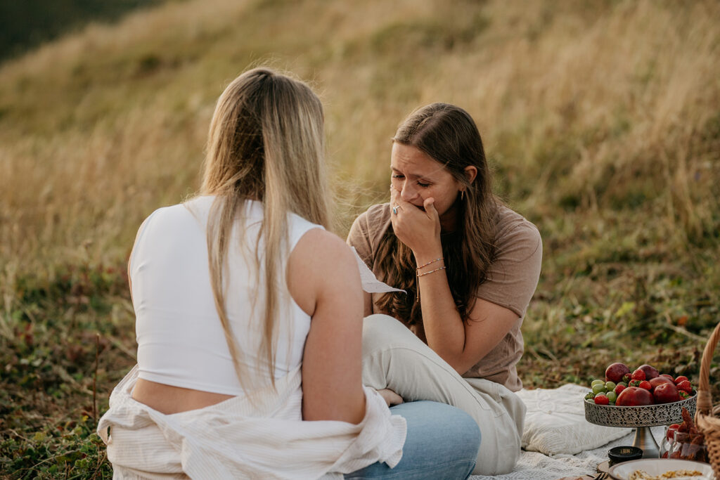 Two women having an emotional picnic moment