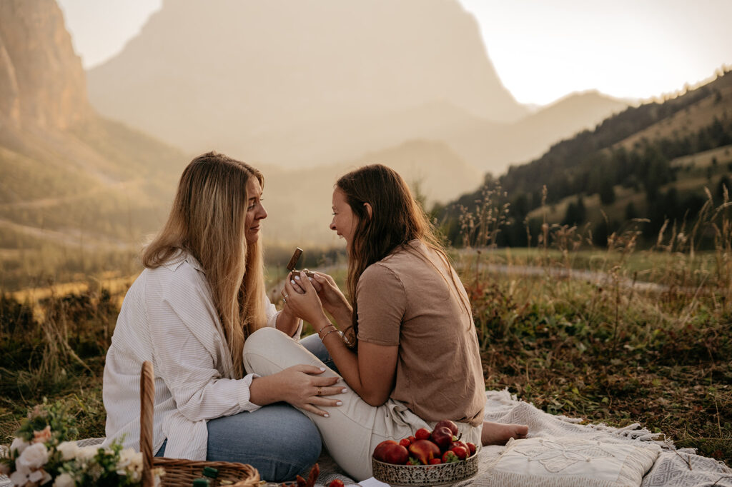 Couple enjoying picnic in scenic mountain setting.