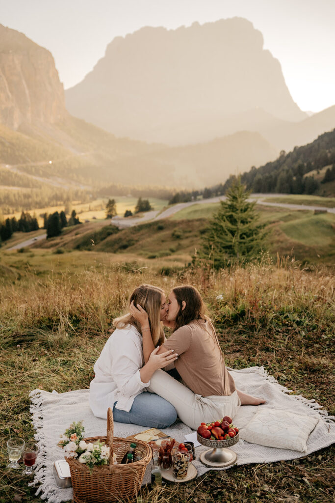 Couple kissing during a romantic mountain picnic