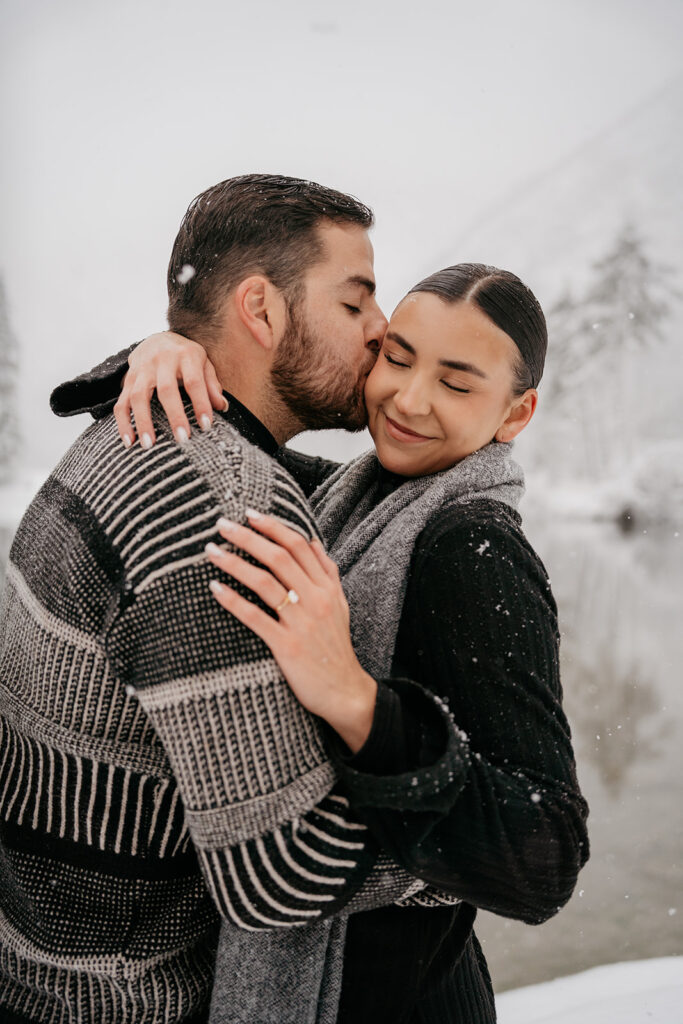 Couple embracing in snowy winter landscape