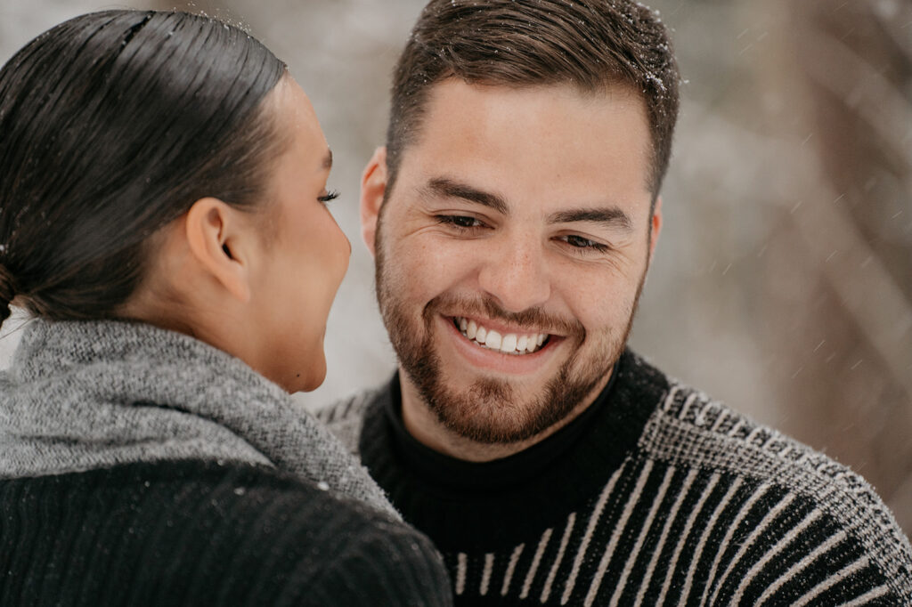 Smiling couple in winter clothing outdoors.