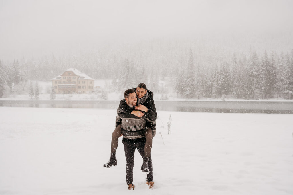 Couple enjoying snowy day in winter landscape