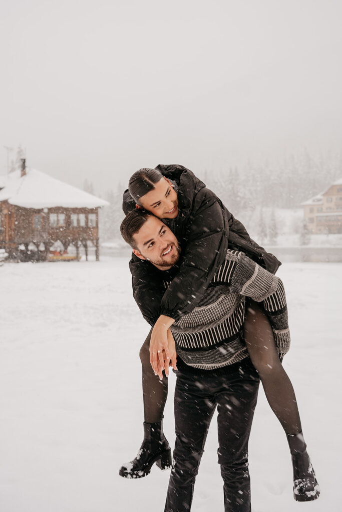 Couple playing in snowy landscape