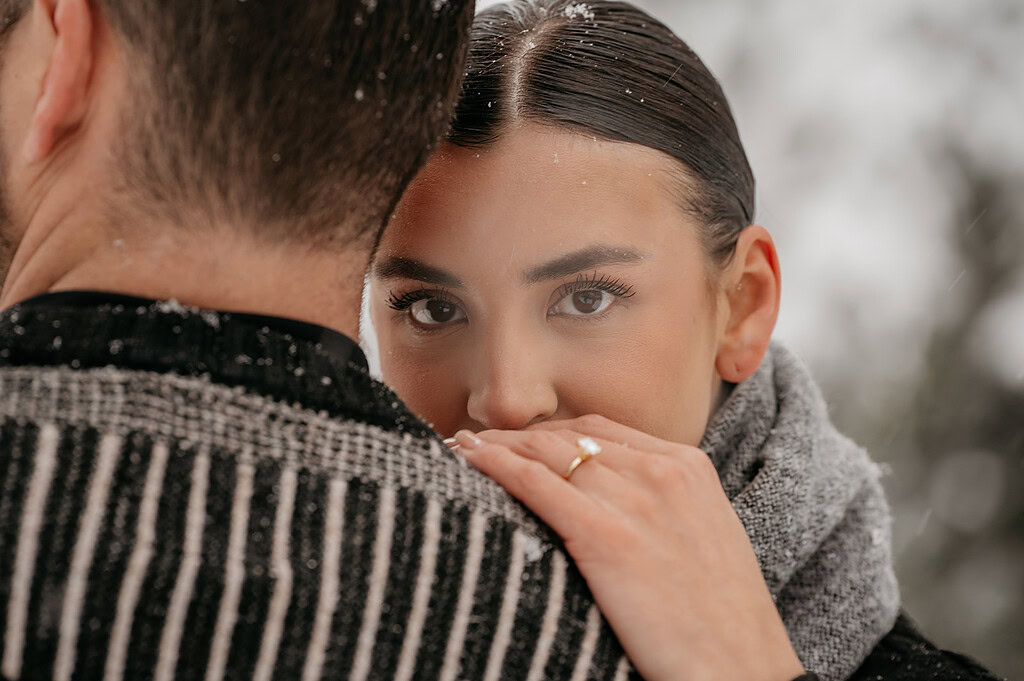 Woman embracing man in snowy setting