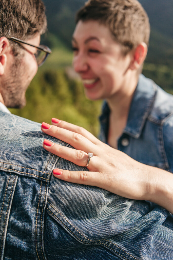 Close-up of hand with engagement ring on shoulder