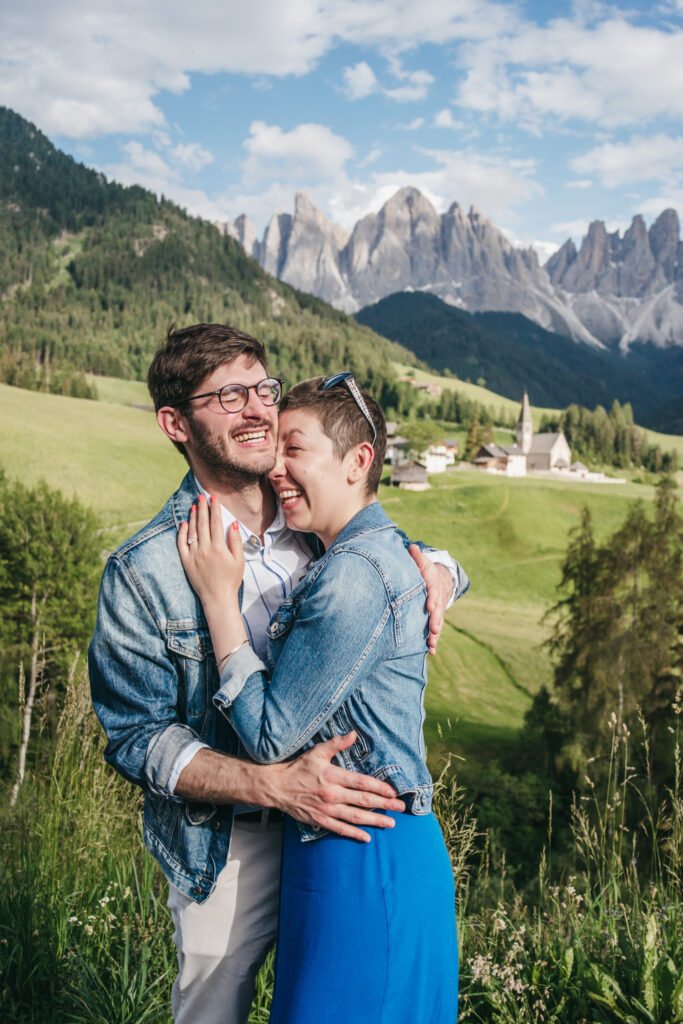 Couple laughing with mountain landscape background