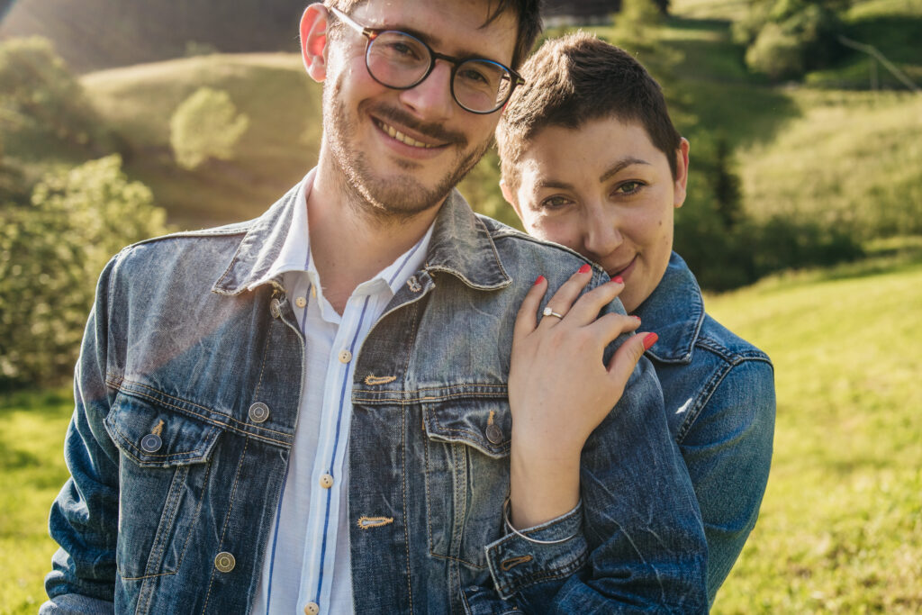 Smiling couple embracing in sunny field