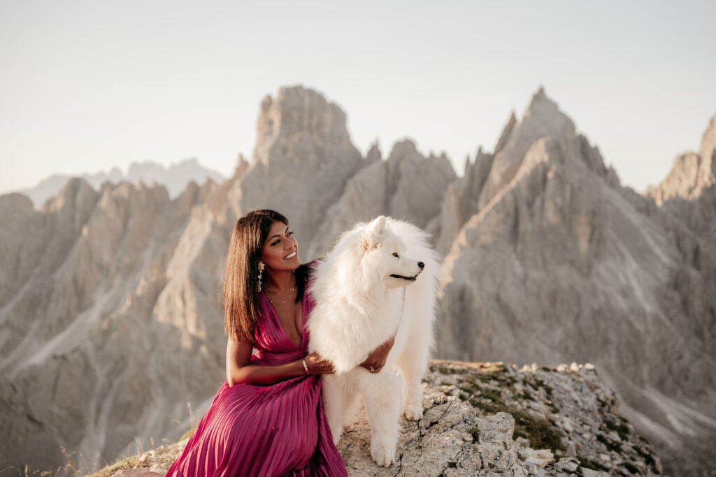 Woman with dog in mountain landscape.