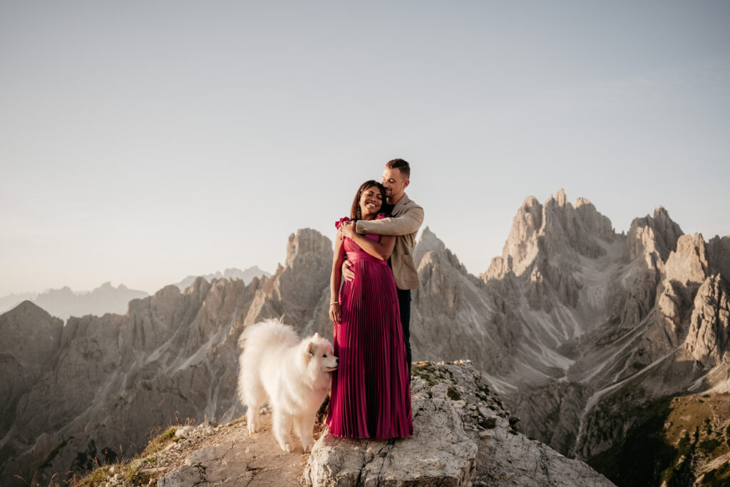 Couple with dog in mountain landscape