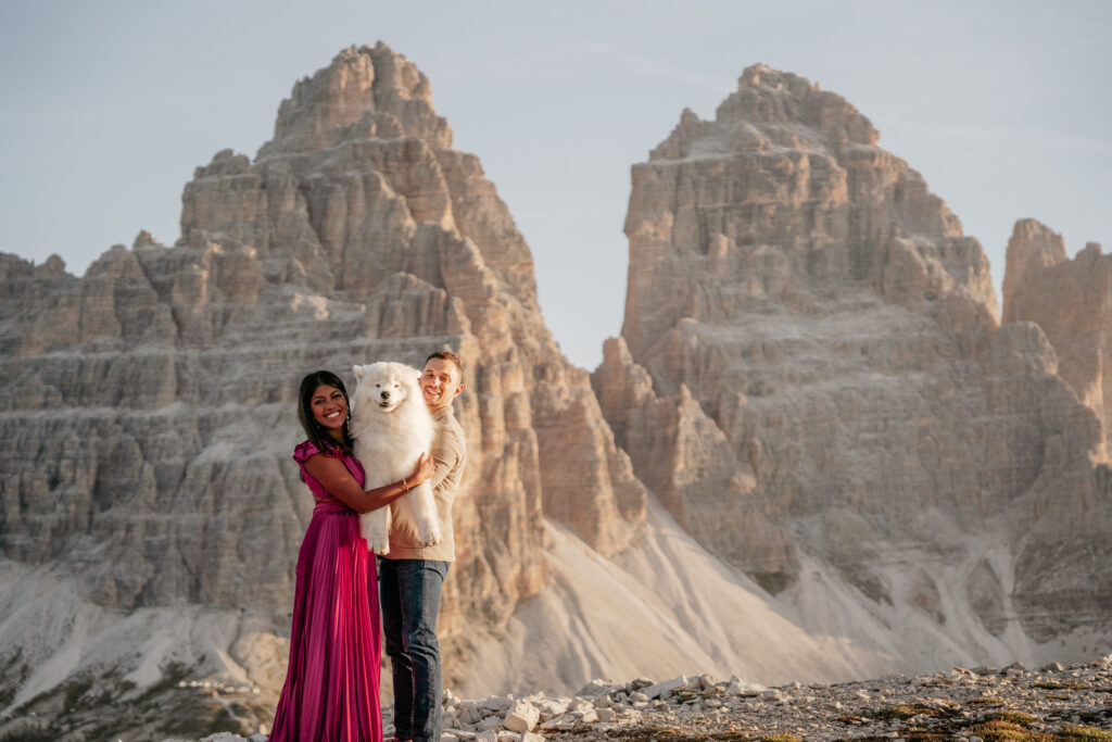 Couple with dog in mountain landscape