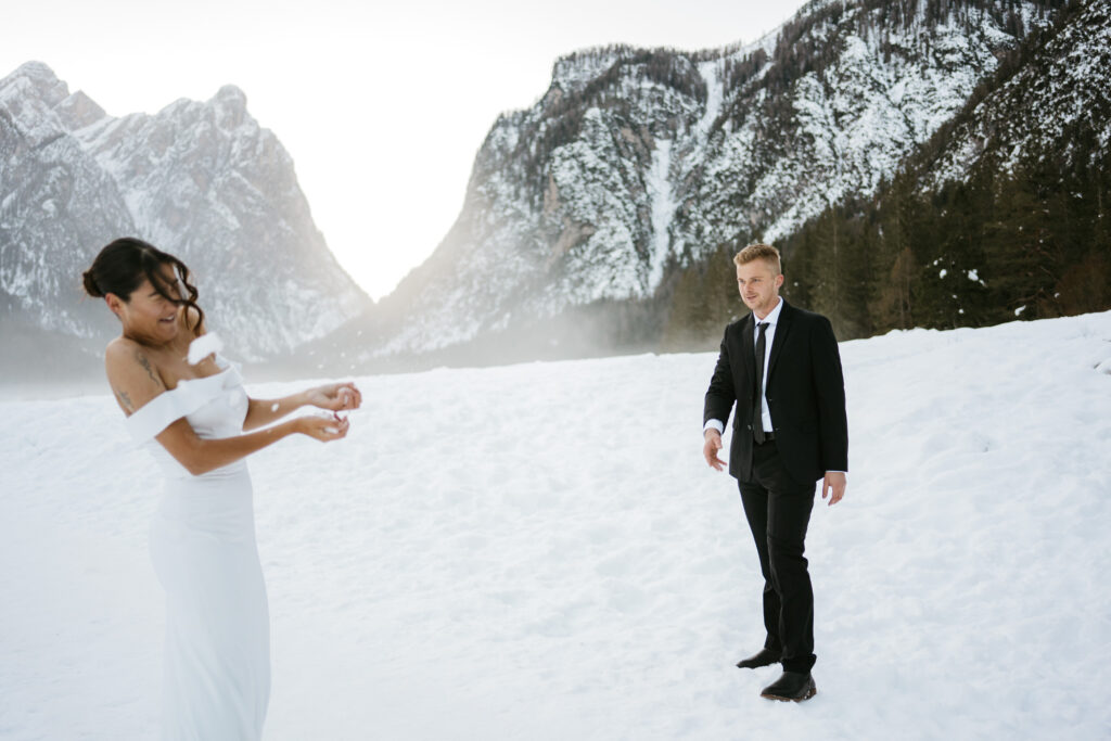 Couple in snow-covered mountain landscape.