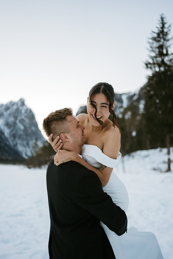 Couple embracing in snowy mountain landscape