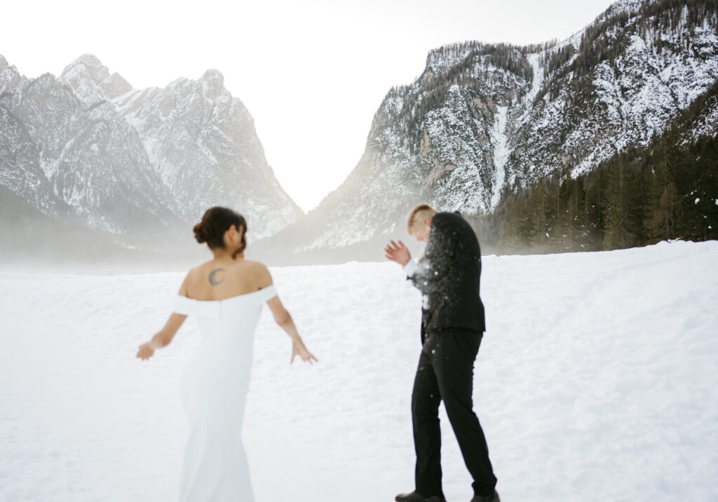 Couple enjoying snowy mountain landscape together.