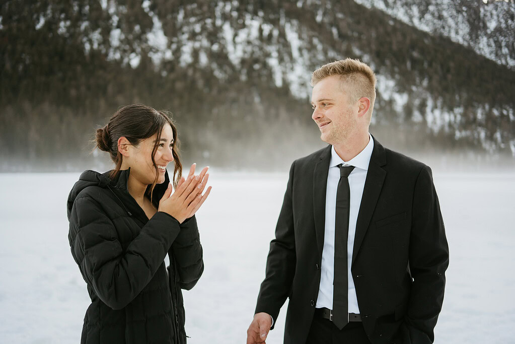 Couple smiling in winter landscape