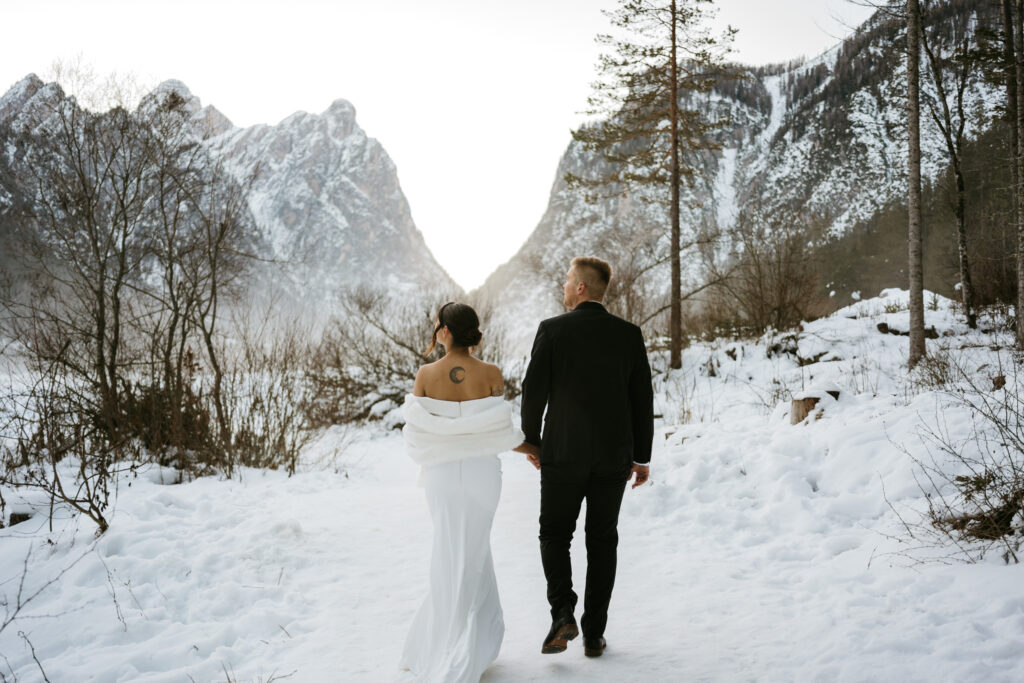 Couple walking in snowy mountain landscape