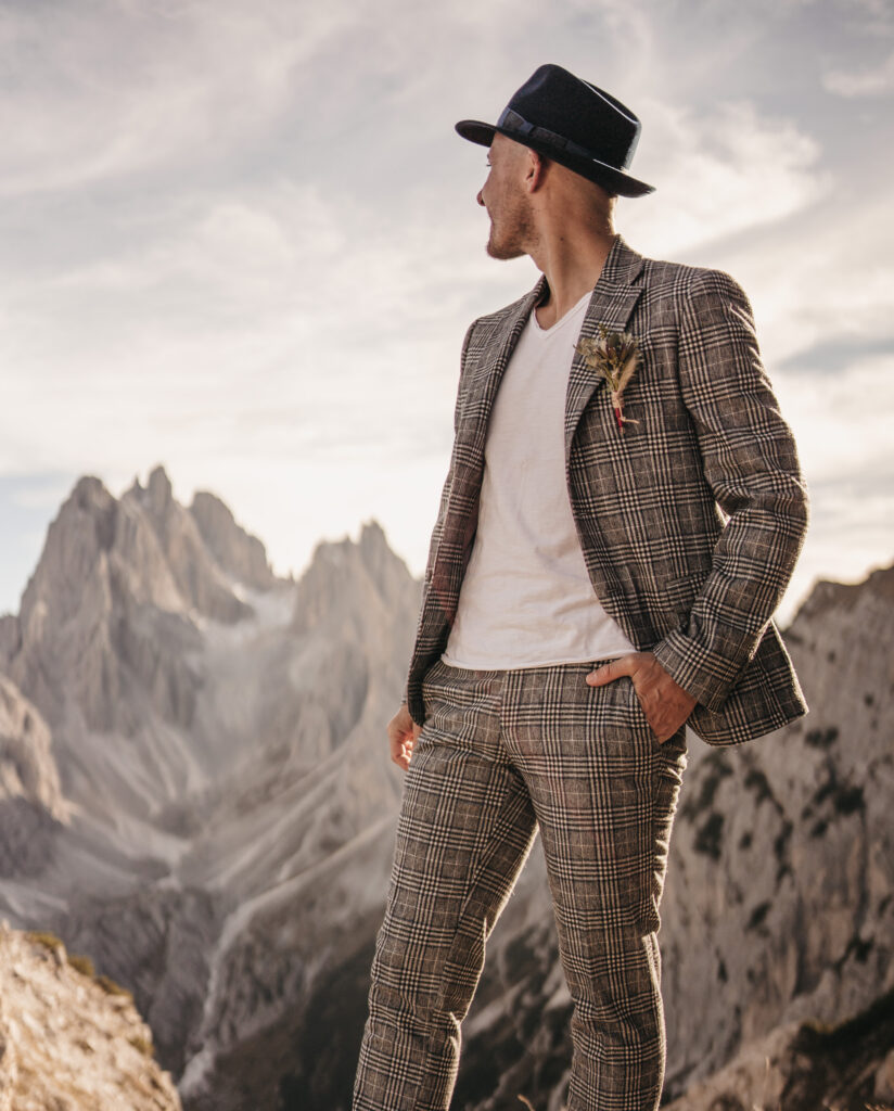 Man in plaid suit, mountains in background