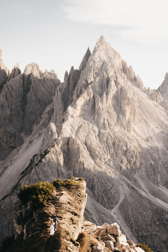 Couple walking on rocky mountain trail