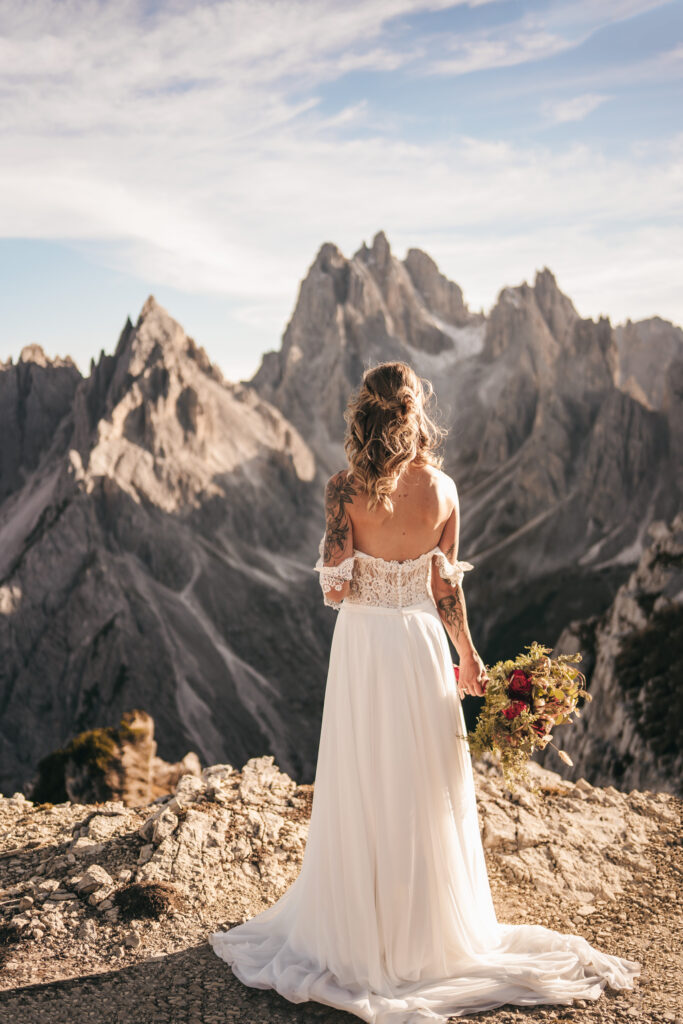 Bride with flowers, mountain scenery background