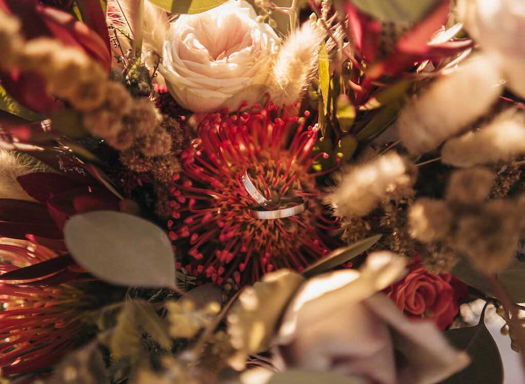 Close-up of colorful wedding bouquet with rings