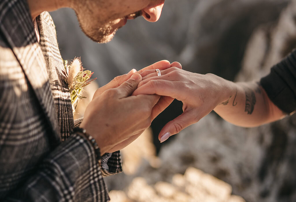 Couple exchanging rings during engagement ceremony