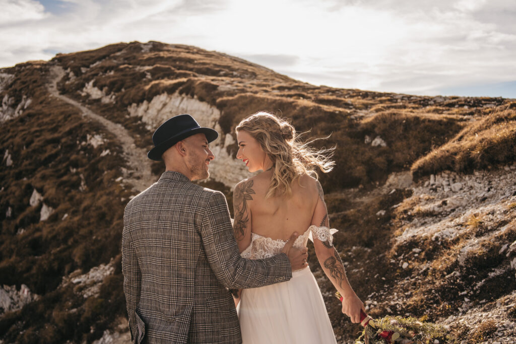 Couple embracing on a scenic mountain trail.