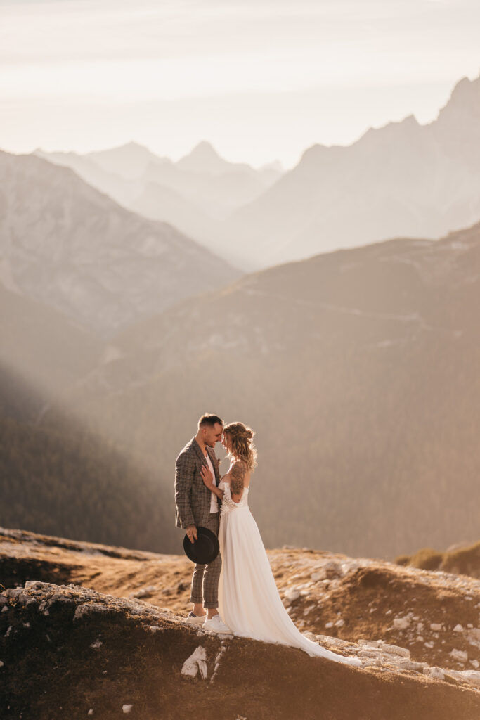 Couple embracing on mountain during sunset