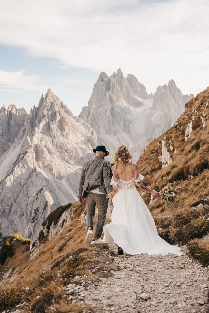 Couple hiking wedding attire mountain background