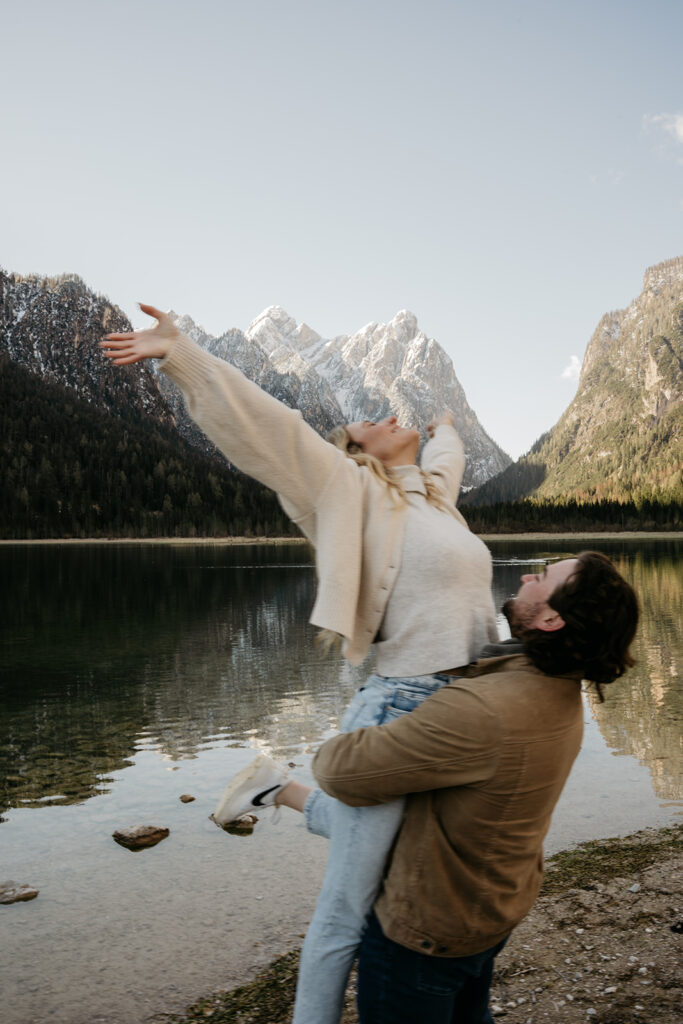 Couple enjoying mountain lake view together.