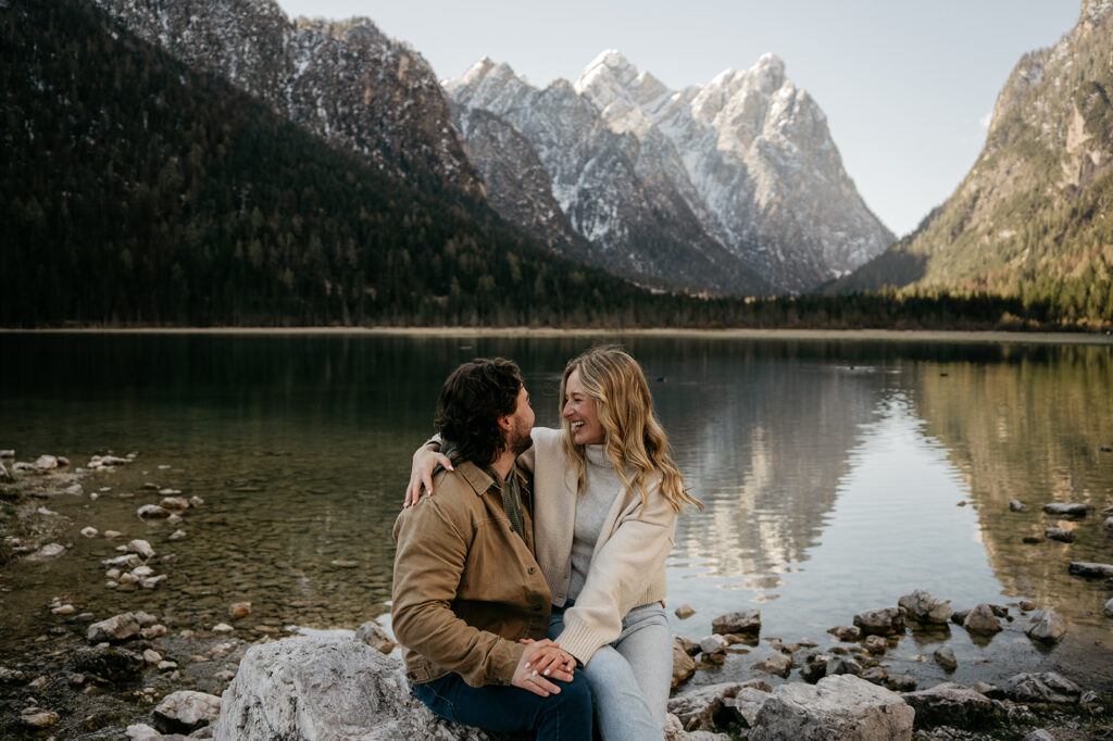 Couple smiling by mountain lake