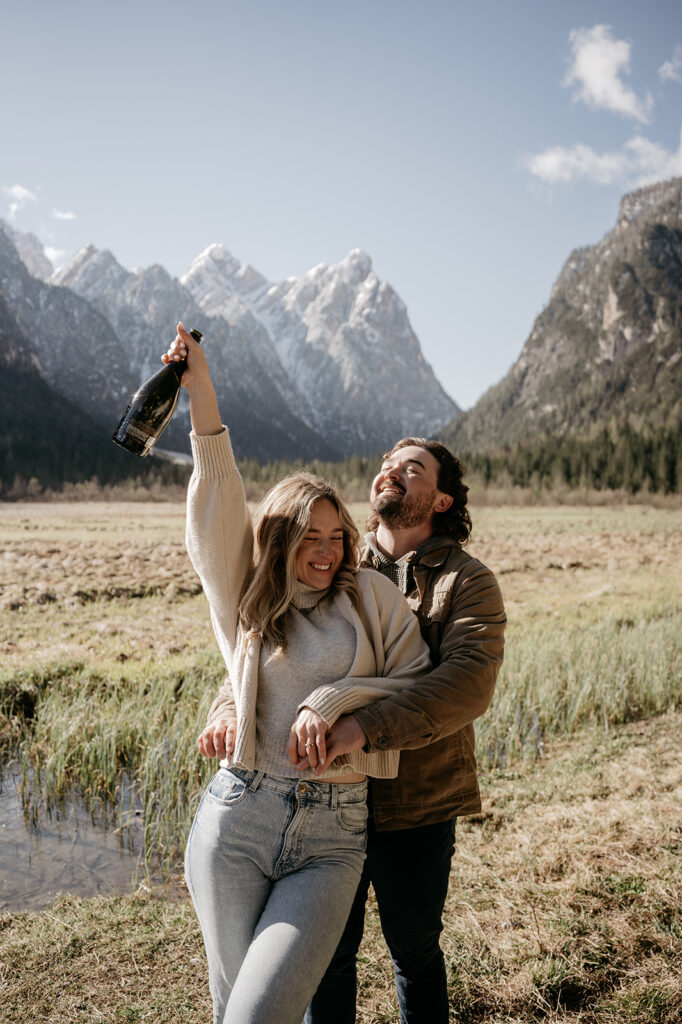 Couple celebrating in scenic mountain landscape