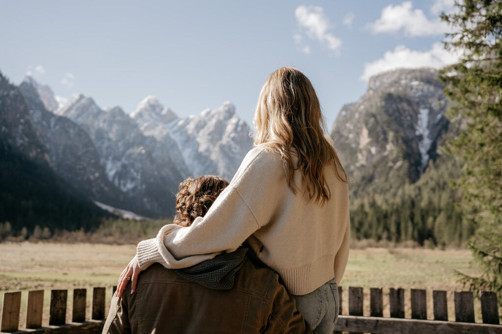 Couple embracing with mountain view in background.