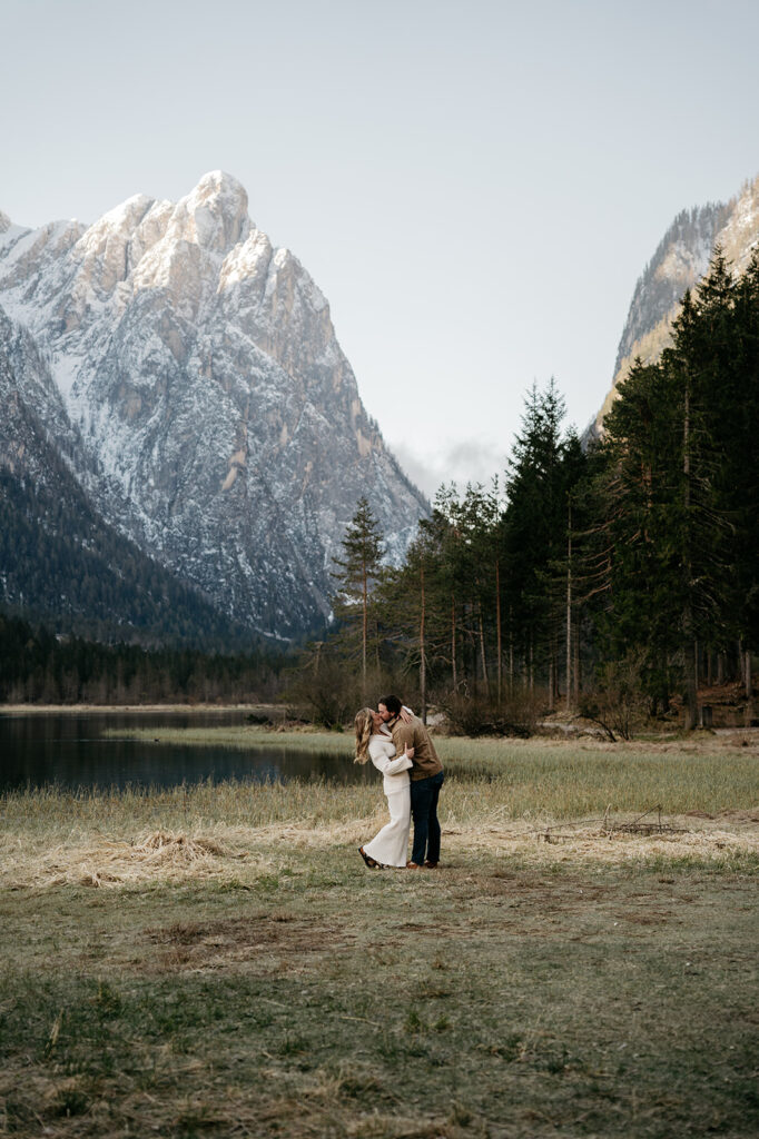 Couple kissing by a mountain lake