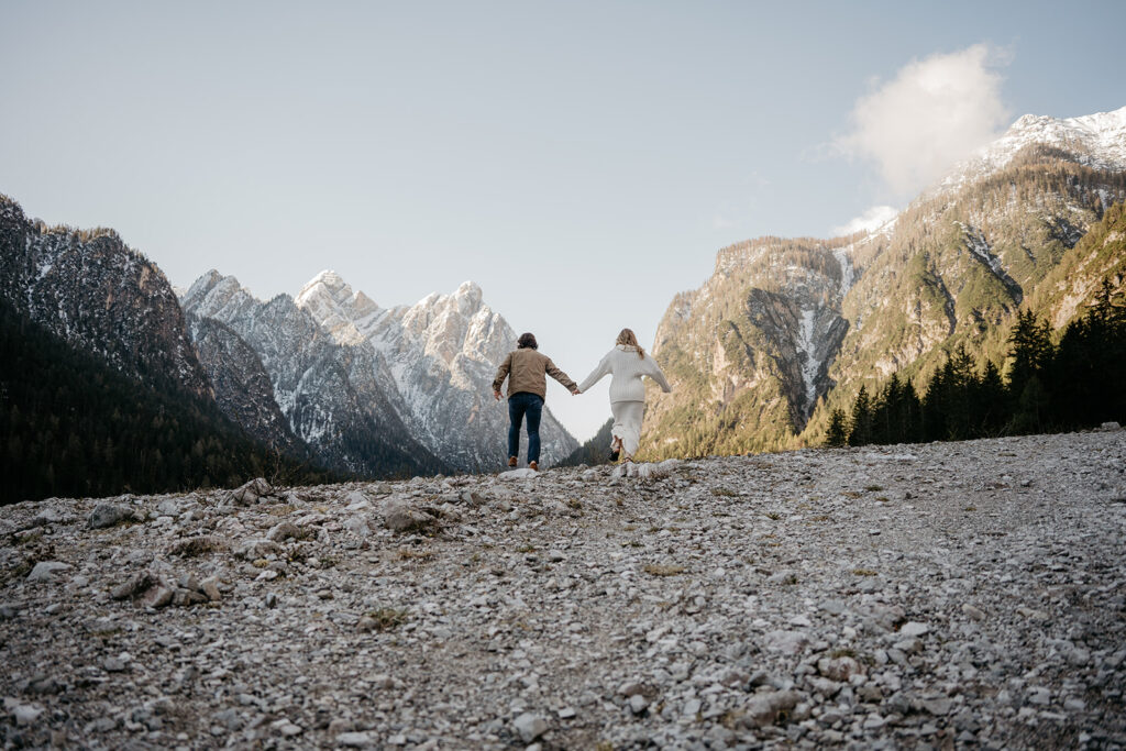 Couple hiking towards scenic mountain view.