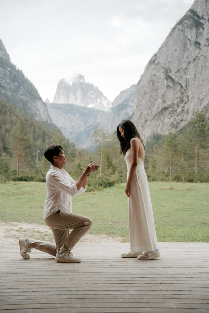 Man proposing to woman in mountain setting