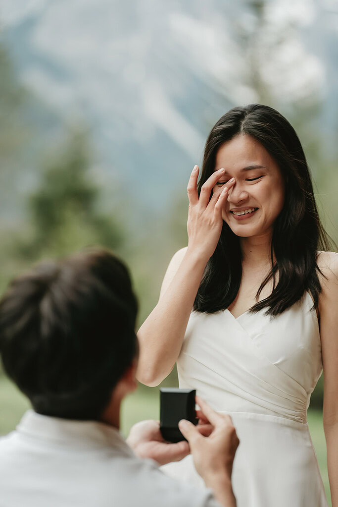 Marriage proposal with engagement ring outdoors