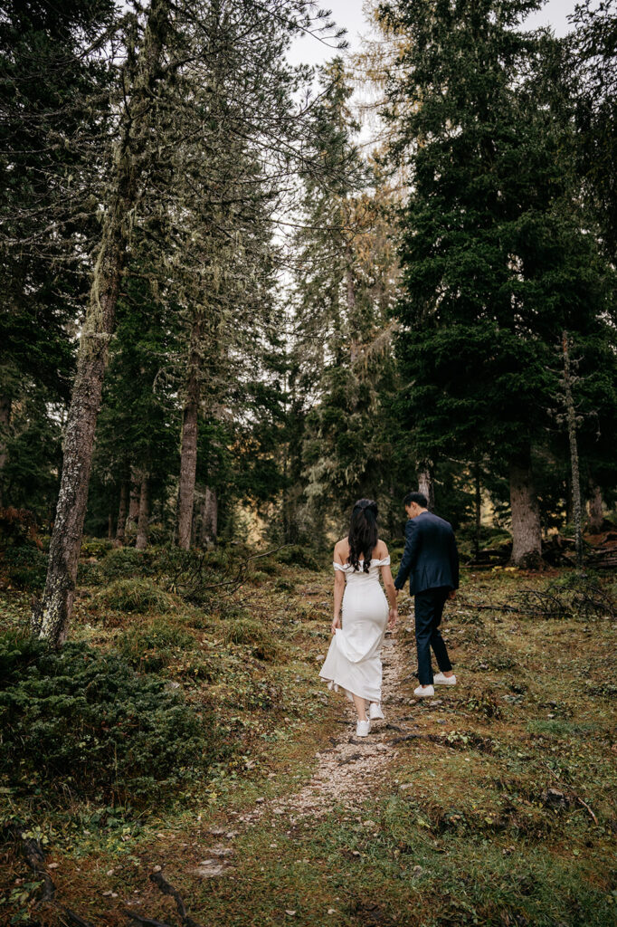 Couple walking through a forest path.