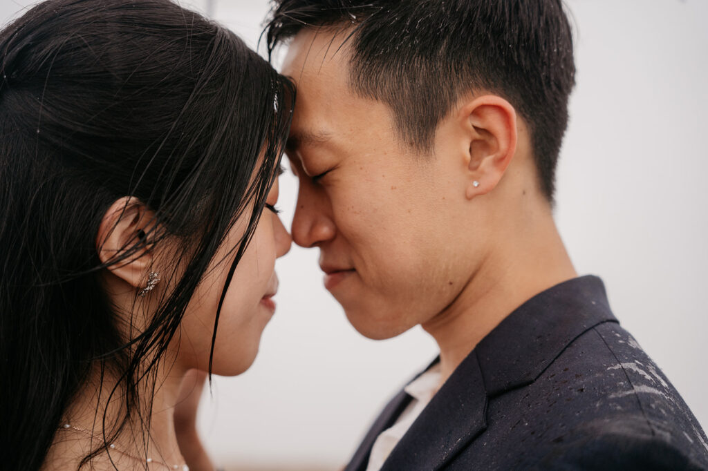 Couple sharing an intimate moment, forehead to forehead.