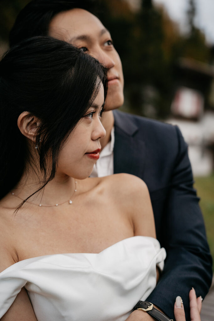 Couple embraces, woman in white dress